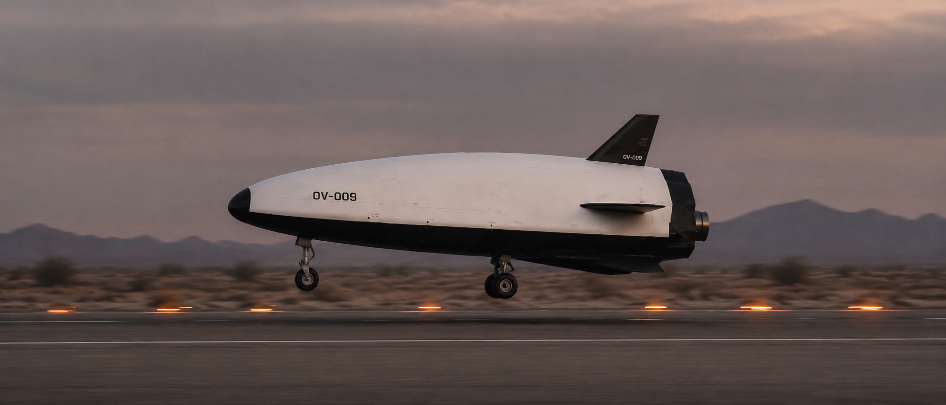 BX-100 touching down on a desert runway at dusk
